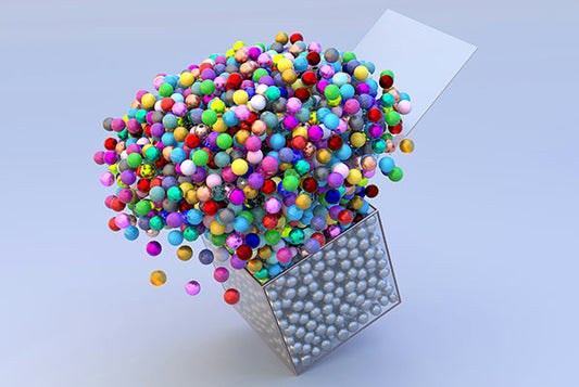 Colorful beads bursting out of a box signifying thinking"Ouside-the-box" 